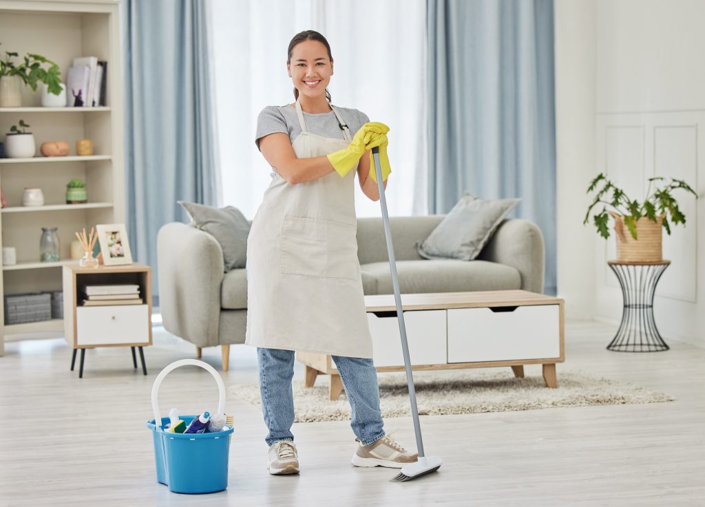 Portrait,,Broom,And,A,Woman,Cleaner,Sweeping,The,Living,Room